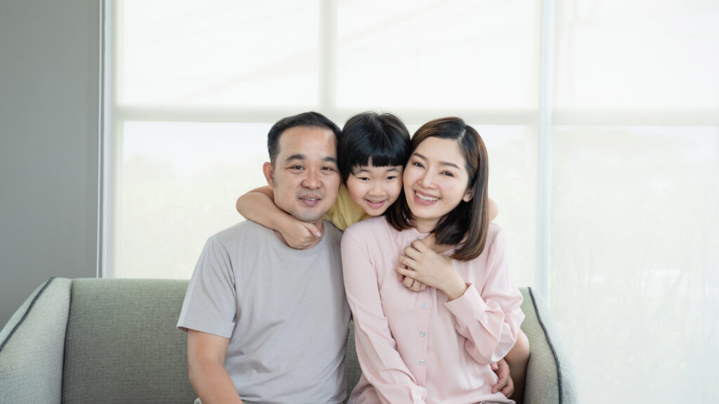 Happy Asian family with son playing at home and everyone having